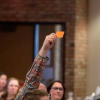 person with orange paper in air